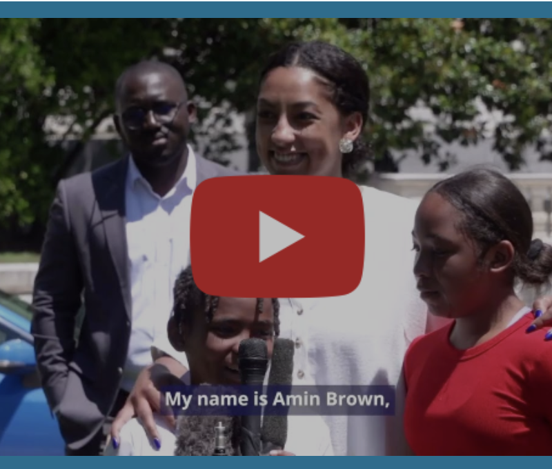 A still from the new "Broken Hope" video shows a man in the background and a woman in the foreground, flanked by two children